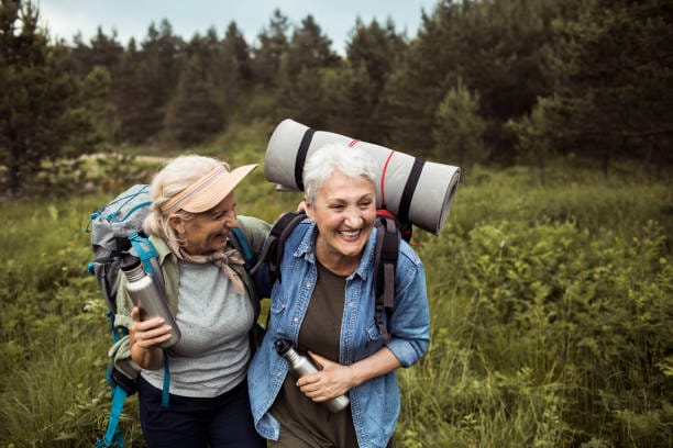 LONGEVITY 101: Why a strong body fuels a sharp mind 1 Close up of two senior female friends hiking together