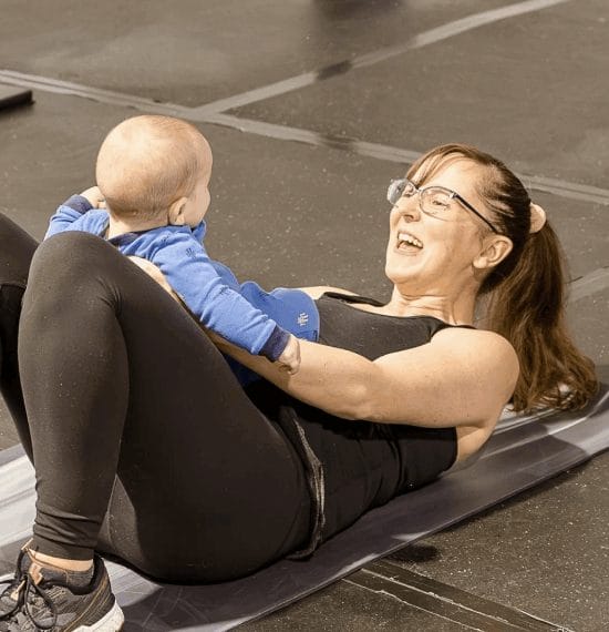 Young woman training with her baby