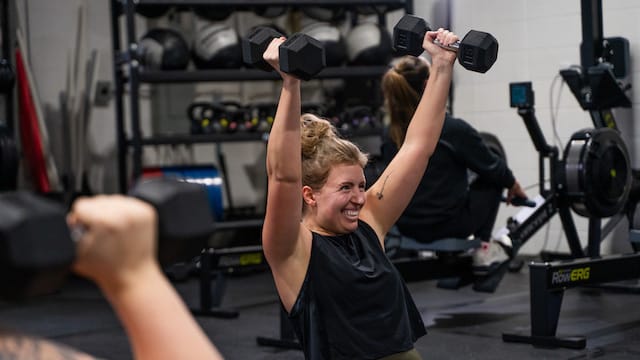 How Do I Do It All and Exercise Too? 1 Woman Exercising with Dumbbells in a Gym